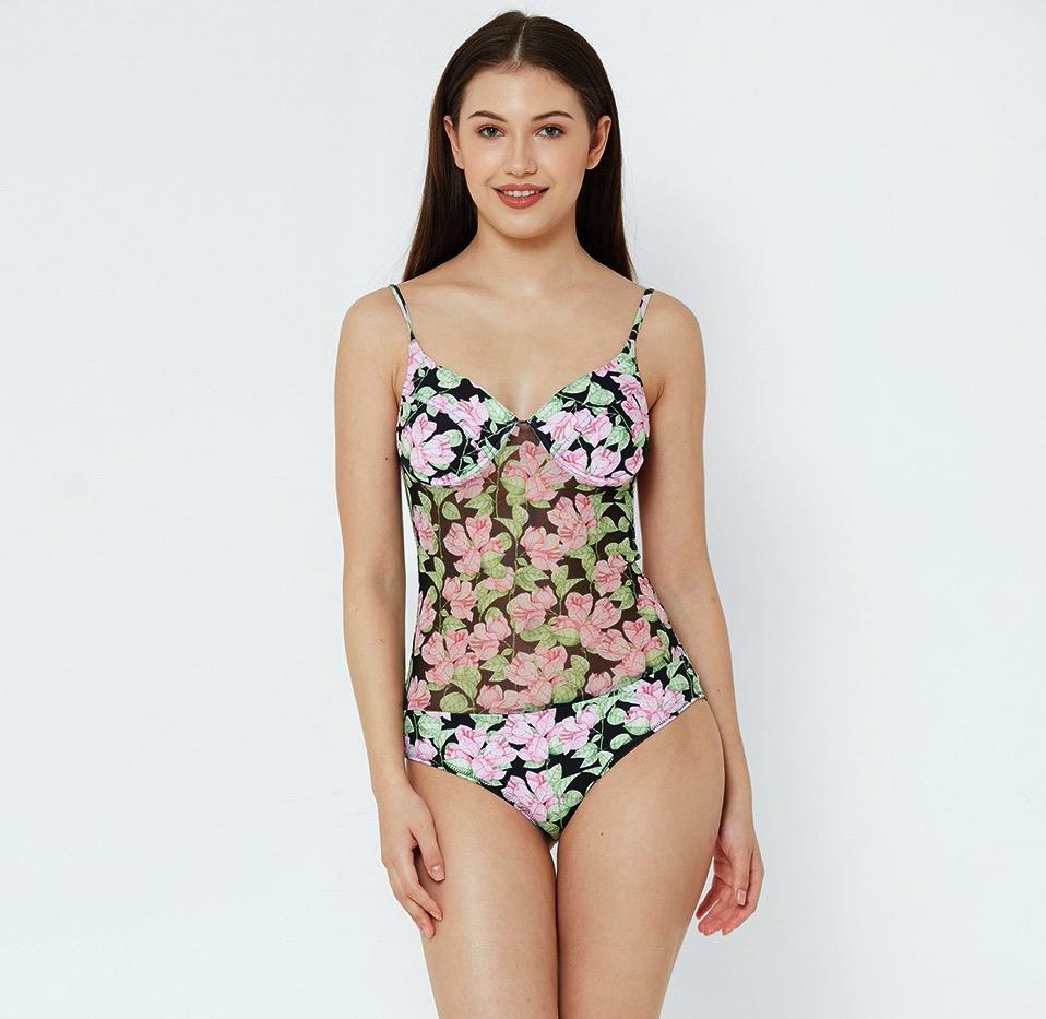 woman wearing Esha Lal swimwear one piece swimsuit with mesh and flower print